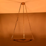 Chain-suspended brass bowl chandelier illuminated at night with warm ambient glow