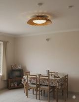 Brushed brass bowl flush mount ceiling light installed in a dining room creating soft ambient and decorative uplighting