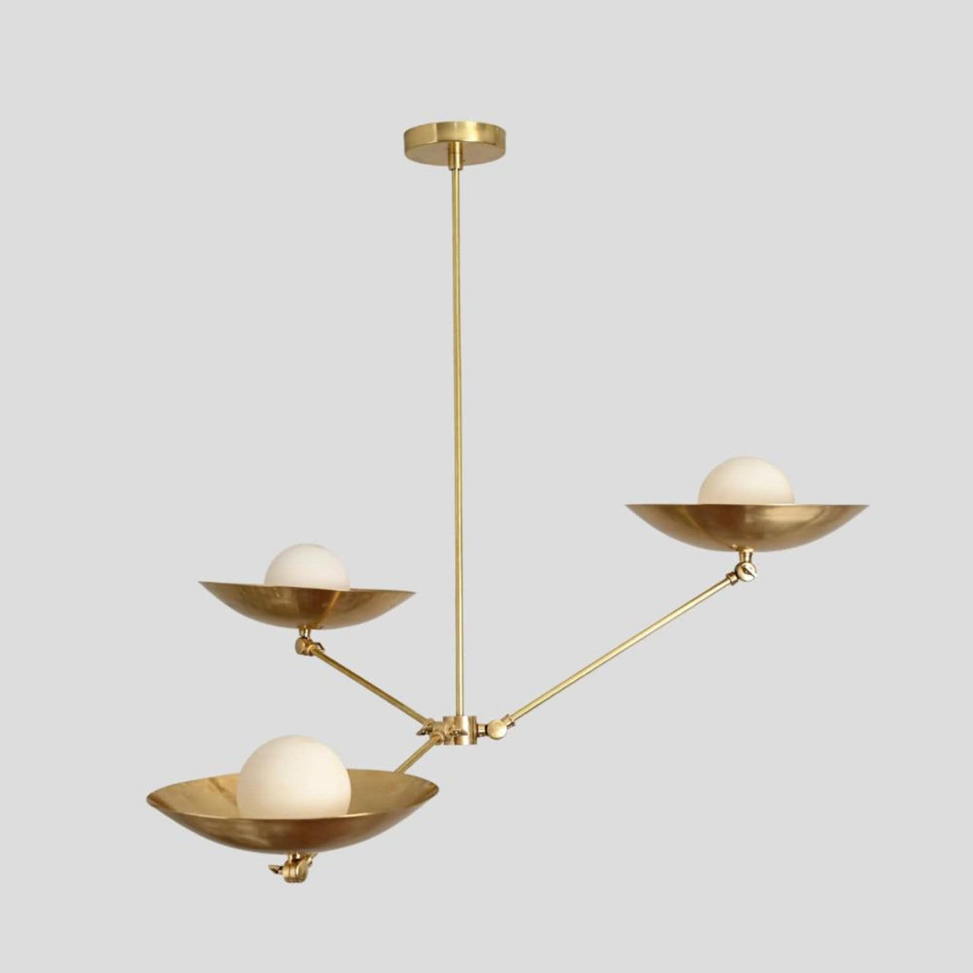 Handmade brass chandelier with three frosted globe bulbs in bowl-shaped brass shades, minimalist ceiling pendant by Brass Leaf Studio.