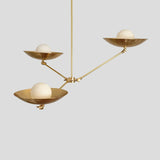 Brass 3-light chandelier showing balanced arm design with bowl shades and frosted bulbs, perfect for dining or living spaces.