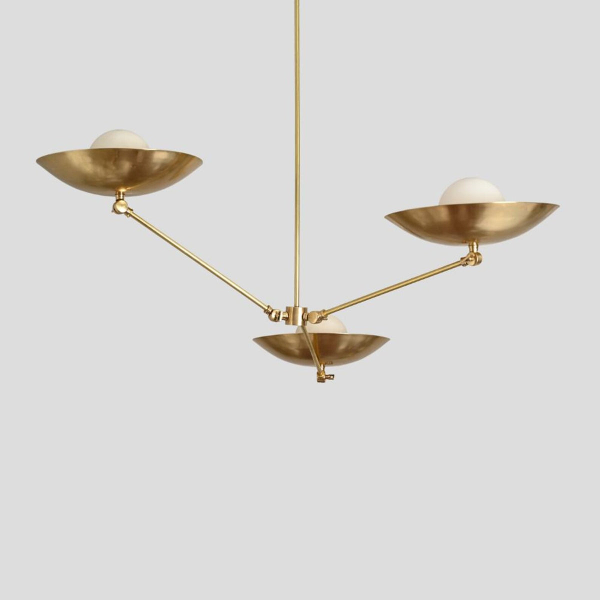 Elegant handmade brass chandelier with three frosted globes and sculpted bowl shades, modern ceiling light by Brass Leaf Studio.
