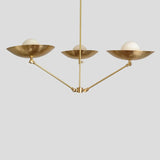 Contemporary brass chandelier with three bowl shades and frosted bulbs, handmade lighting fixture blending modern and industrial style.