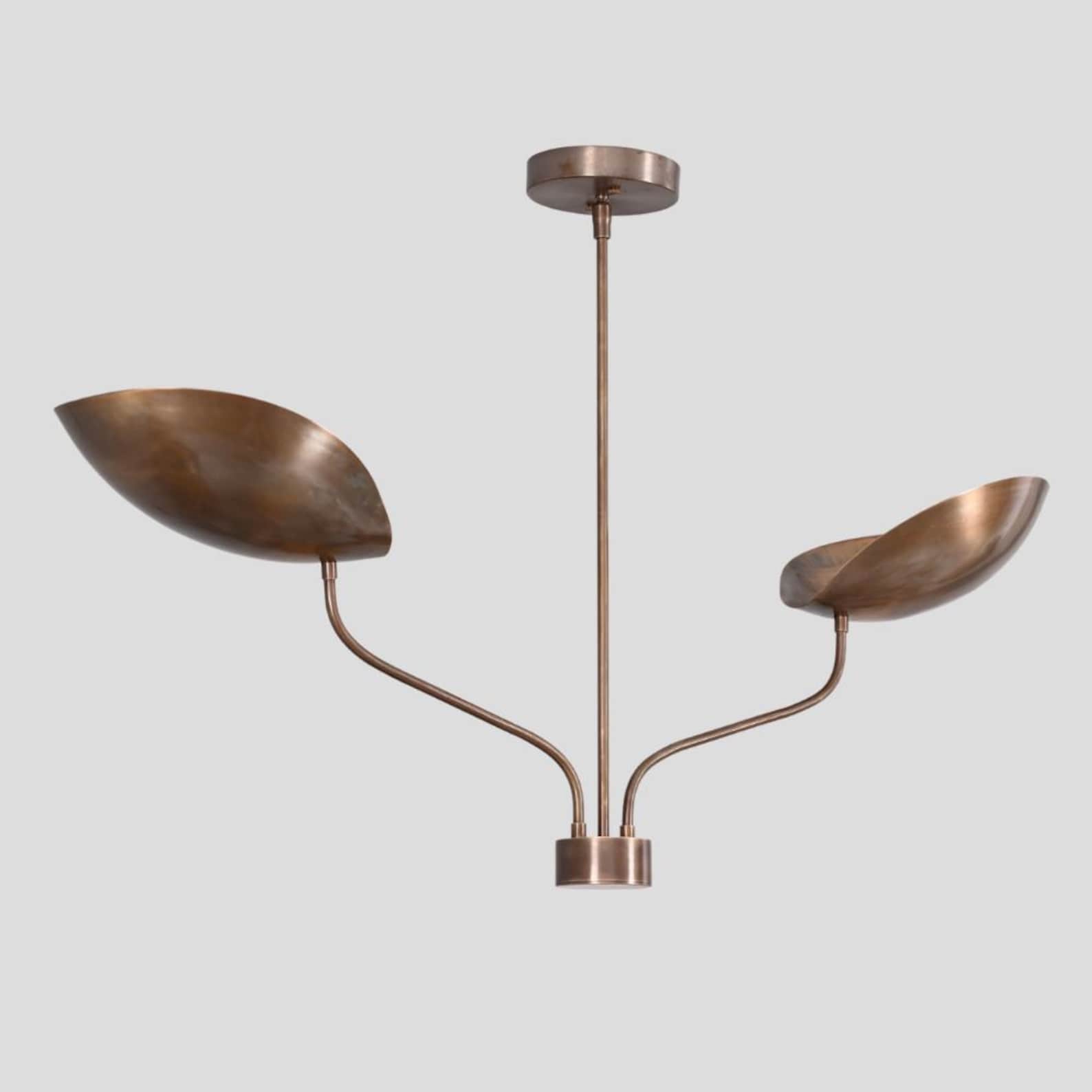 Close view of brass chandelier with two bowl-shaped shades, handcrafted minimalist industrial ceiling light by Brass Leaf Studio.