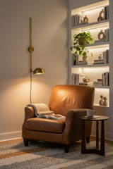 Solid brass bowl shade wall sconce with long vertical stem, round wall canopy, and extended arm for bedside or reading lighting