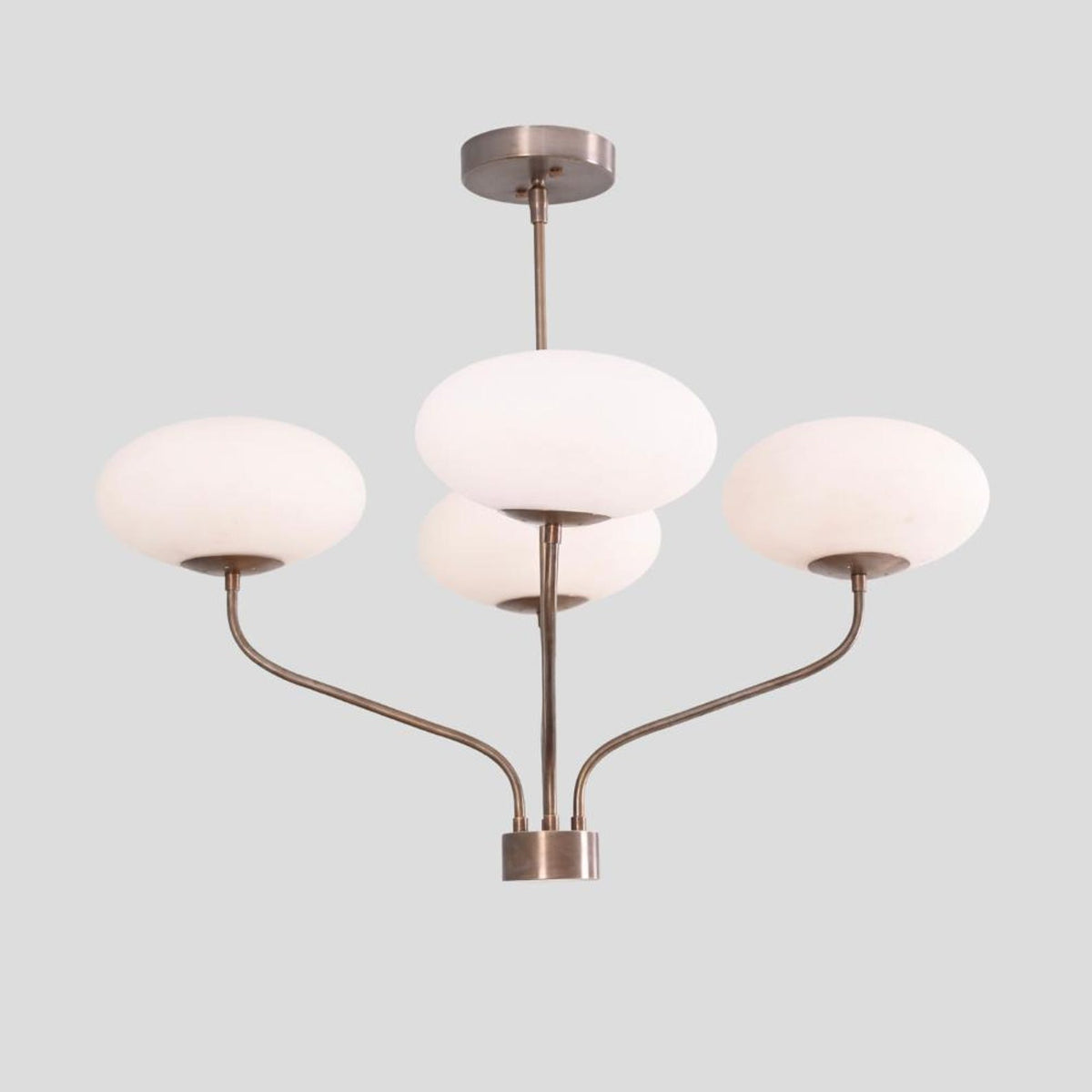 Brass ceiling chandelier featuring four curved arms with frosted bowl glass shades, elegant handmade lighting fixture.