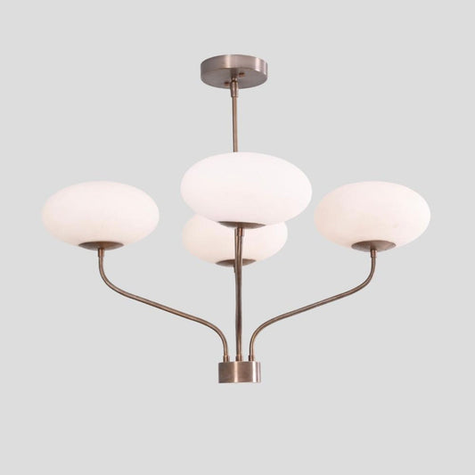 Brass ceiling chandelier featuring four curved arms with frosted bowl glass shades, elegant handmade lighting fixture.