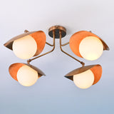 Four-light brass ceiling fixture with sculpted dome brass shades and frosted white globes.