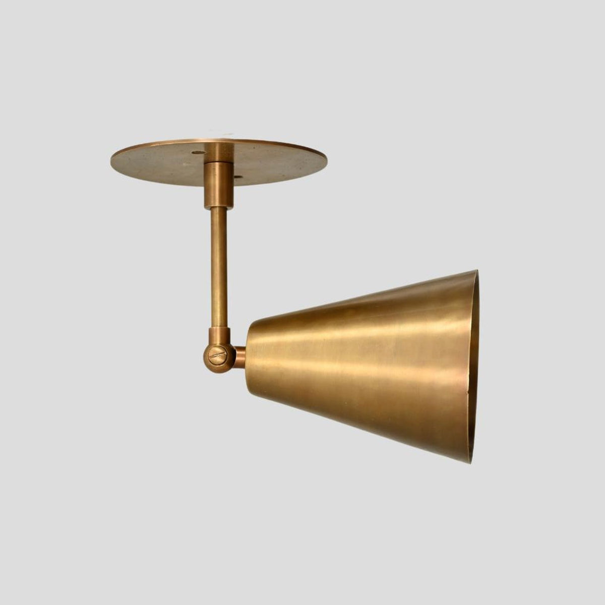 Front view of handcrafted solid brass ceiling lamp with cone shade and industrial look