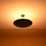 Warm ambient glow from 5-light brass ceiling chandelier – uplighting design