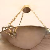 Suspended brass chandelier glowing against a ceiling, ideal for luxury interiors