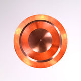 Warm glowing bottom view of the multi-layer brass chandelier with soft indirect lighting illuminating the circular copper shades.