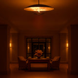 Elegant brass chandelier illuminating a hotel or foyer setting with warm diffused glow, perfect for lounges and entryways