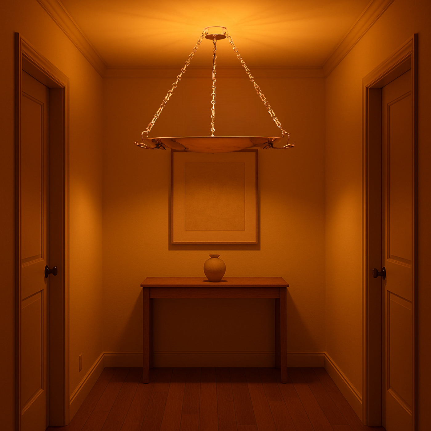 Brass bowl chandelier casting ambient glow in elegant hallway, suspended by golden chains