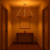 Brass bowl chandelier casting ambient glow in elegant hallway, suspended by golden chains