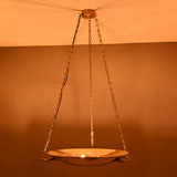 Brass chandelier turned on – radiating golden uplight for ambient lighting effect