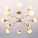 Top-down view of brass chandelier with multiple white glass globes