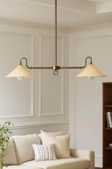 Mid-century modern brass cone chandelier suspended above a sofa with clean lines and balanced symmetry