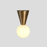 Modern brass flush mount ceiling light with conical mount and glowing opal globe – handmade by Brass Leaf Studio