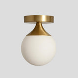 Handmade brass flush mount ceiling light with conical mount and opal glass globe – modern minimalist design