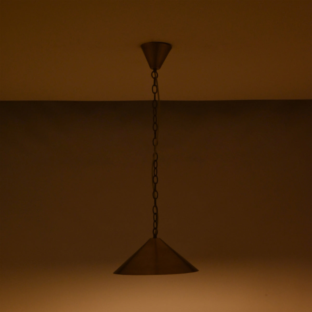 Brass cone pendant light on white background showing chain suspension, ceiling canopy, and wide shade design