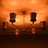 Close-up of perforated brass cone shade showing intricate light diffusion and handcrafted detailing.
