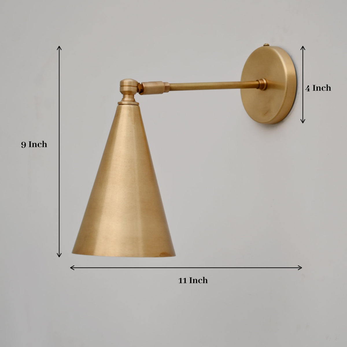 Brass cone wall light showing product dimensions—9-inch height, 11-inch projection, and 4-inch backplate diameter.