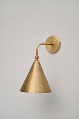 Minimalist brass cone wall sconce with industrial design, perfect for bedrooms, cafes, and boutique interiors