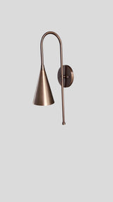 Side profile of brass wall sconce with cone-shaped shade and lacquer finish