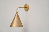 Side view of handmade brass cone wall sconce with brushed finish, designed for contemporary interiors