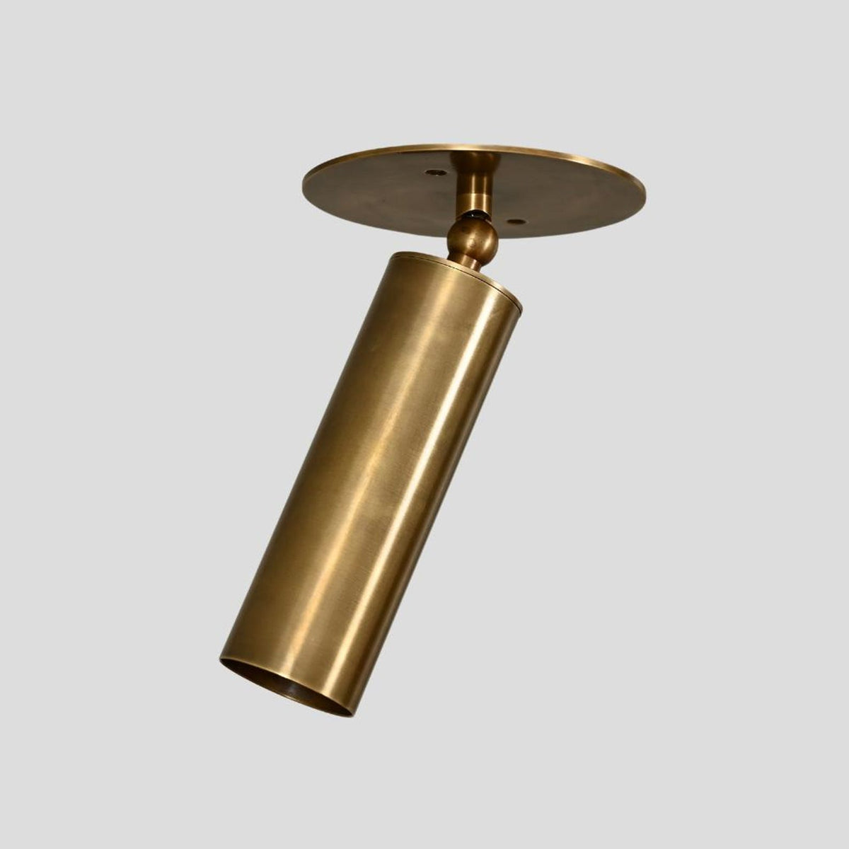 Handmade brass cylinder ceiling spotlight with adjustable head, minimalist industrial style lighting fixture.