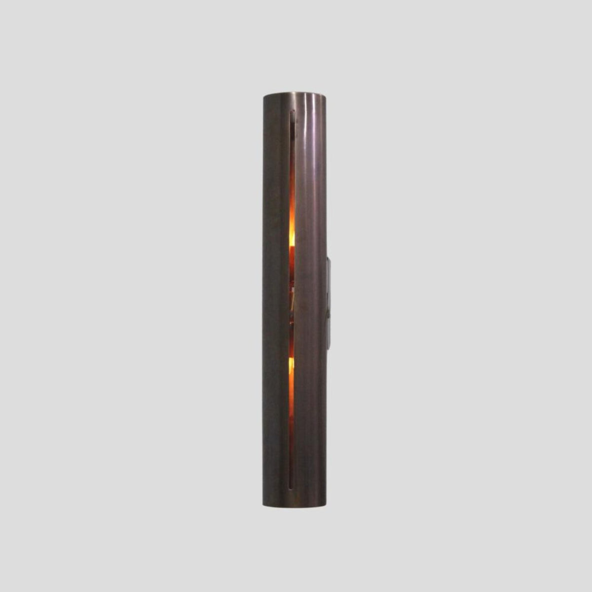 Ambient glowing brass wall sconce with vertical slit design, minimalist modern lighting fixture handmade by Brass Leaf Studio.