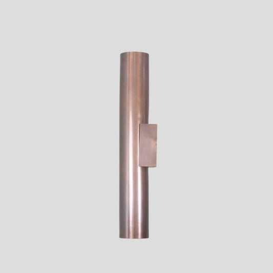 Side view of minimalist brass cylinder wall sconce, solid brass construction with brushed finish, designed for modern interiors.