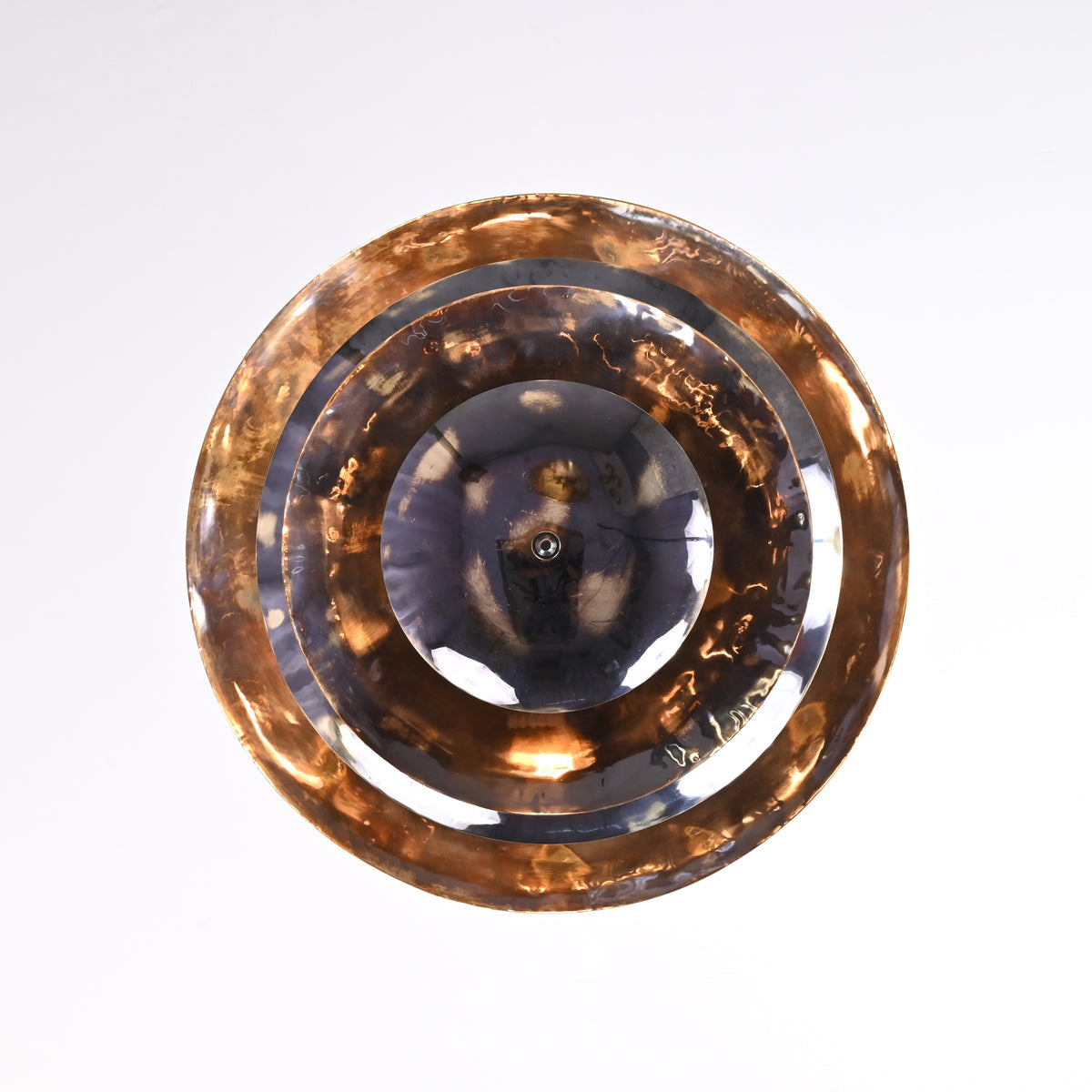Bottom view of multi-tier brass disc chandelier with reflective polished and hammered textures