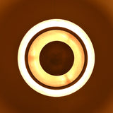 Artistic view of brass chandelier creating concentric ring lighting effect on ceiling