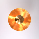 Top view of brass disc ceiling chandelier with polished inner surface and central brass dome