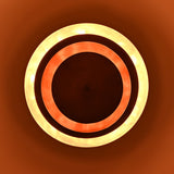 Glowing brass chandelier emitting layered indirect lighting with copper tones and soft ambient radiance