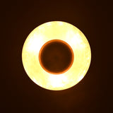 Top-down glowing view of brass pendant light emitting warm indirect illumination