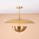 Handmade brass disc pendant light with dual dome design in brushed brass finish, shown against beige background