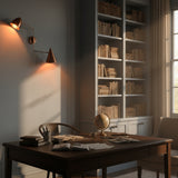 Brass wall sconce with one dome shade, one cone shade, copper patina finish, and artistic adjustable arm layout