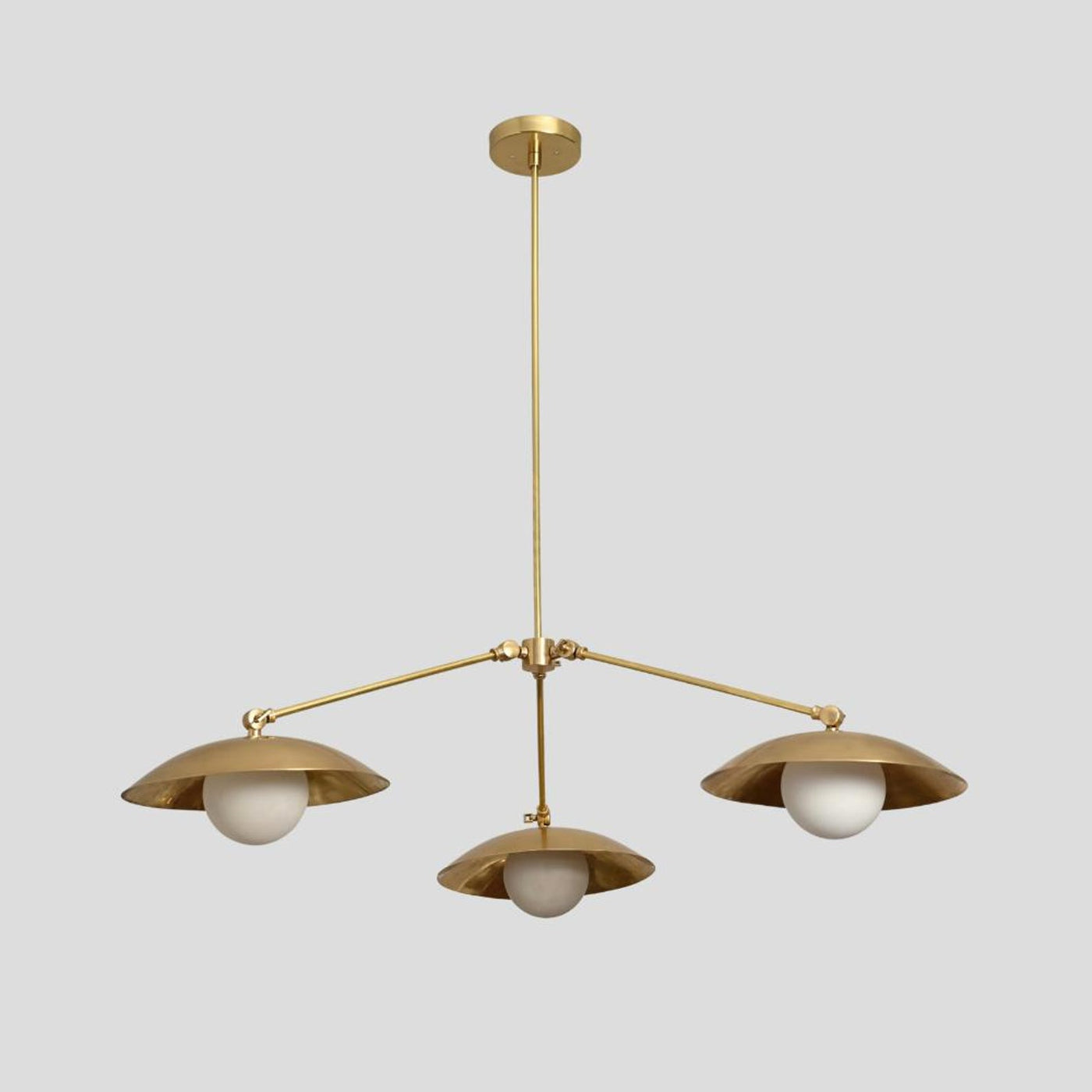 Handmade brass chandelier with three frosted globe bulbs and dome-shaped brass shades, minimalist ceiling pendant by Brass Leaf Studio.