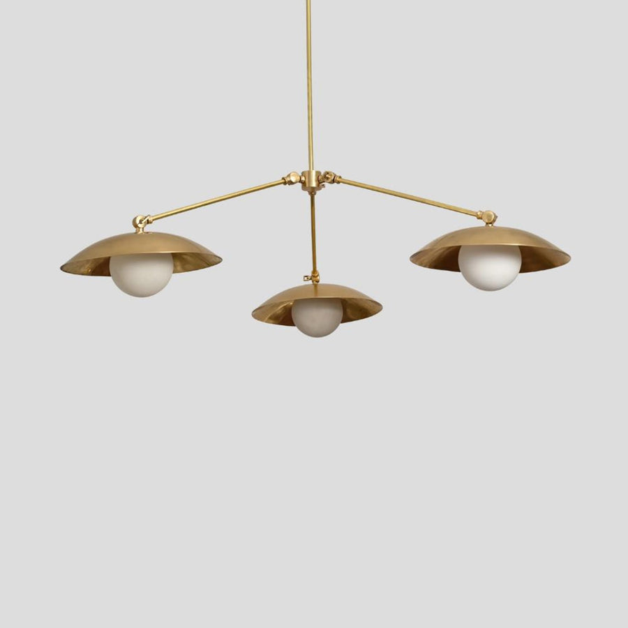 Handmade brass chandelier with three frosted globe bulbs and dome-shaped brass shades, minimalist ceiling pendant by Brass Leaf Studio.