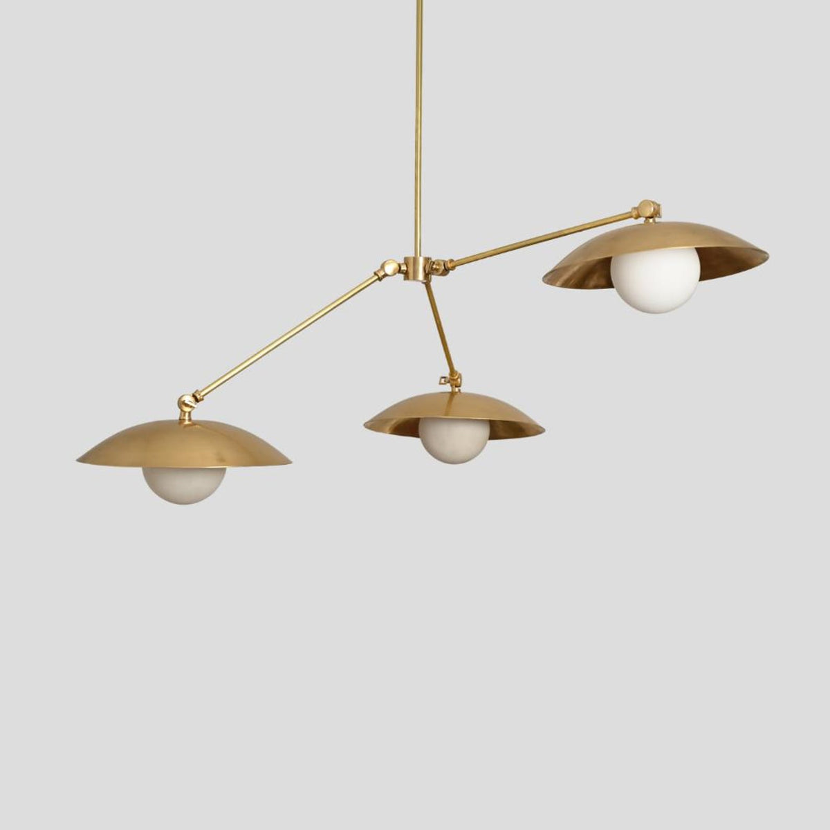 Contemporary handmade brass chandelier with frosted globes and sculpted dome brass shades, suspended ceiling pendant light.