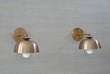 Elegant brass dome wall sconces with solid brass arms – straight-on wall view
