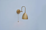 Elegant brass dome wall light featuring a smooth brushed brass shade and pull chain switch, ideal for bedrooms or hallways.