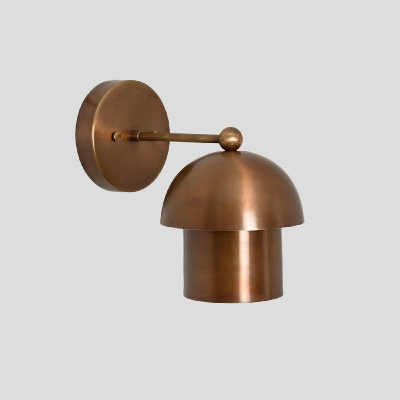 Handmade brass dome wall sconce with round backplate and curved dome shade