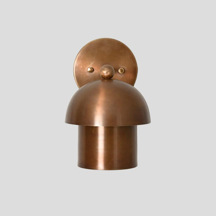 Front view of brass dome wall sconce featuring rounded dome shade design