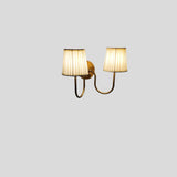 Elegant brass wall sconce with twin pleated fabric shades – styled presentation