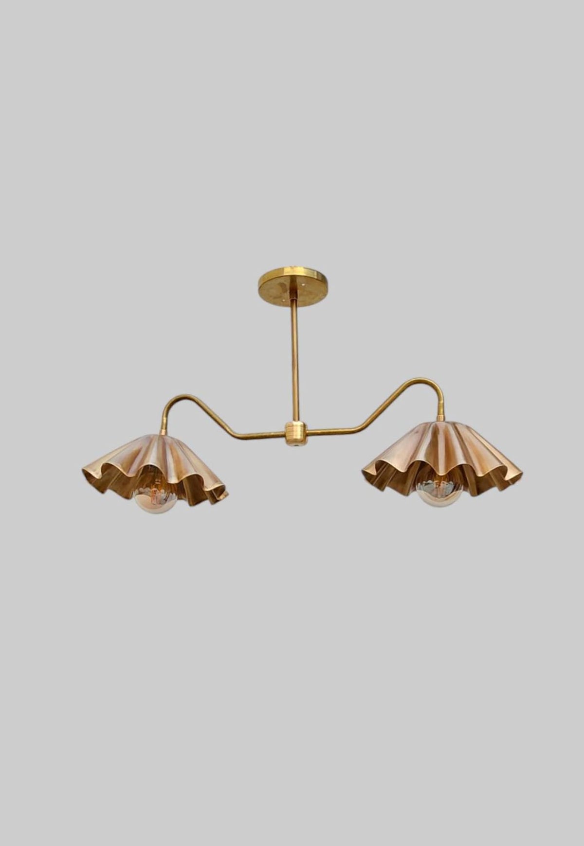 Modern brass ceiling light with dual wavy shades and elegant flush mount design