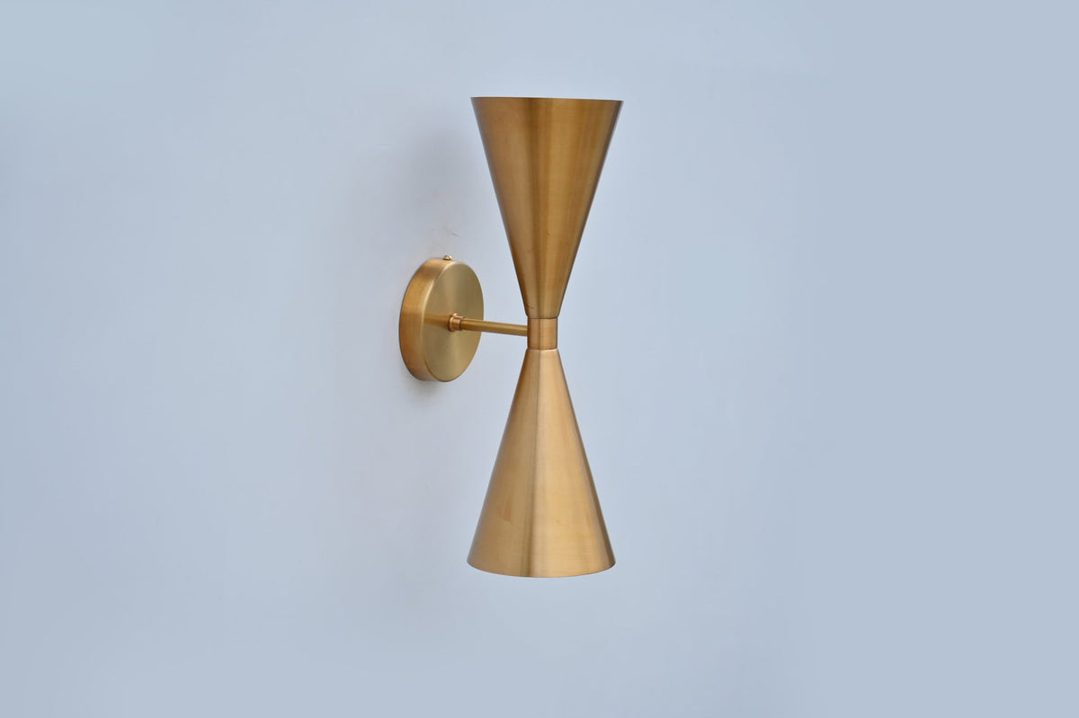 Contemporary double cone wall light in pure brushed brass, minimalist handcrafted lighting fixture for modern interiors.