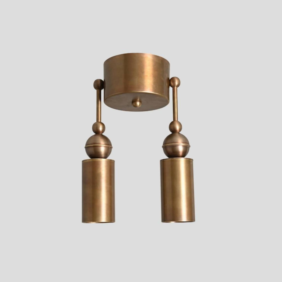 Brass double cylinder ceiling flushmount light, straight front view highlighting sleek handcrafted design